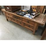 A large rustic teak coffee table with drawer