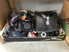 A box of cameras and accessories