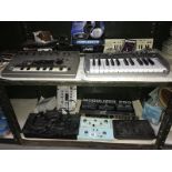 2 shelves of recording instruments etc for musicians including keyboards, pedals etc.