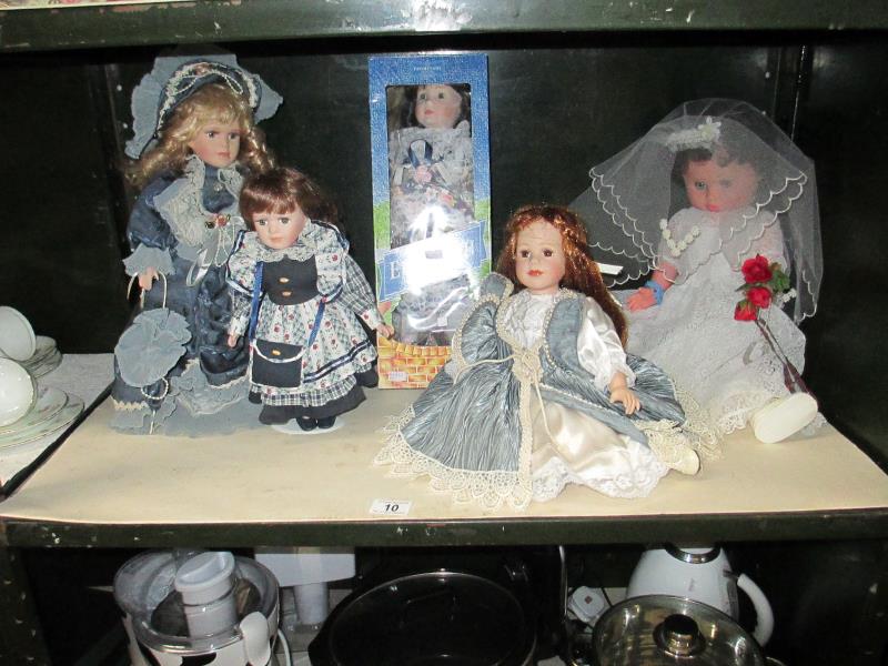 4 porcelain dolls and 1 other,