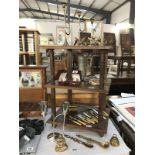 3 shelves of brass ware including boxed napkin rings, trumpet shaped graduating candlesticks etc.