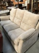 A cream fabric 3 seater settee