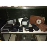 A shelf of camera t.v. radio etc.