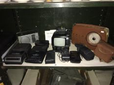 A shelf of camera t.v. radio etc.