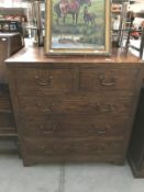 A solid teak chest of drawers with brass handles