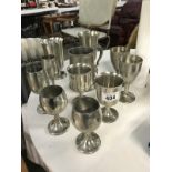 A quantity of pewter goblets and tankard