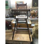 A 1930's oak metamorphic childs highchair