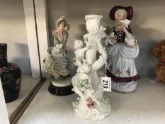 A cherub candlestick and 2 figurines