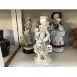 A cherub candlestick and 2 figurines