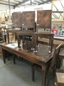 A large rustic teak dining table with parquet top and 5 chairs