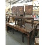 A large rustic teak dining table with parquet top and 5 chairs