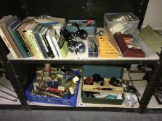 2 shelves of fishing related items including fishing reels, lure bait hooks, books etc.