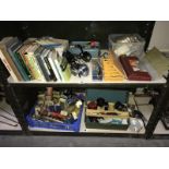 2 shelves of fishing related items including fishing reels, lure bait hooks, books etc.