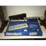 A Hohna Melodica Cassotto 26 and a boxed Midismart keyboard