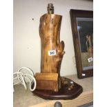 An unusual carved wooden table lamp base with house, deckchair,