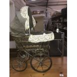 A dolls pram and a vintage Rosebud doll