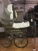 A dolls pram and a vintage Rosebud doll