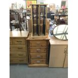A solid pine chest of drawers and revolving pine cd unit