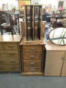 A solid pine chest of drawers and revolving pine cd unit