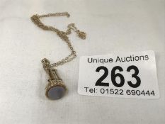 A wicket and cricket bat fob (tests as 9ct) on a 9ct gold chain