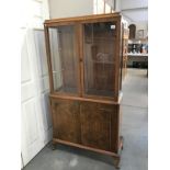 A 1930's walnut veneered display cabinet