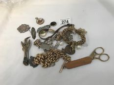 A mixed lot including silver fobs, yellow metal chains etc.