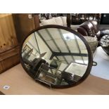 A mahogany framed oval mirror