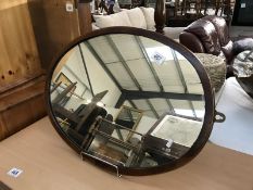 A mahogany framed oval mirror