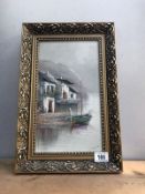 A gilt framed oil on canvas of a boat by buildings