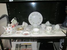 A shelf of cups and saucers, teapots etc.