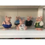 A set of 5 Nat West Wade pigs family money boxes