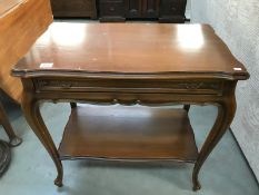 A dark wood stained side table with drawer