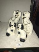 A pair of Staffordshire mantlepiece dogs and a smaller pair