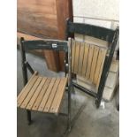 A pair of folding wooden garden chairs