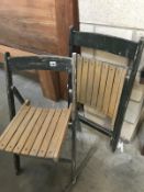 A pair of folding wooden garden chairs