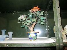 A cloissonne pot with flowers