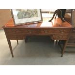 A dark wood stained inlaid writing desk