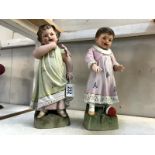 A pair of continental bisque porcelain figures of children (1 a/f)