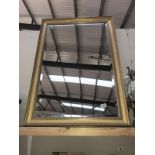A large gilt framed bevelled edge mirror