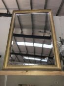 A large gilt framed bevelled edge mirror
