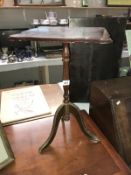A dark wood stained tripod wine/side table