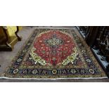 Red ground Persian Tabriz Carpet, with a traditional Tabriz medallion design, size 3.1m x 2.1m
