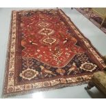 Red ground Persian Kashan Tribal Rug with a treble medallion and several bird motifs, 2.8m x 1.75m