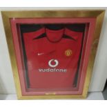 A Manchester United (Vodafone) Jersey, signed “David Beckham”, dated 2002/2003, in a gilt frame (