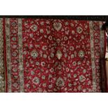 Red Ground Kashmir Carpet with an all-over floral design (as new), 3.30m x 2.40m