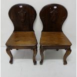 Matching pair pitch pine, mahogany finish Hall Chairs, shield backs with cabriole front legs and