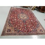 Persian Wool Red Ground Floor Rug, with a central medallion and continuous floral design, 2.50m x