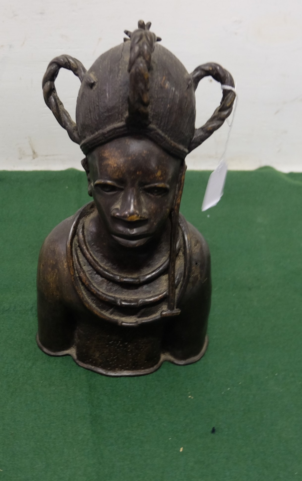 Bronze head and shoulders Bust of a Benin Chieftain, wearing a headdress and a native necklace, 7”