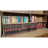 2 shelves of hardback books – encyclopaedias, colourfully bound novels etc