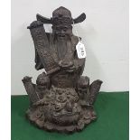 Bronze Study of a Seated and Smiling Chinese Emperor holding an open scroll with two Chinese
